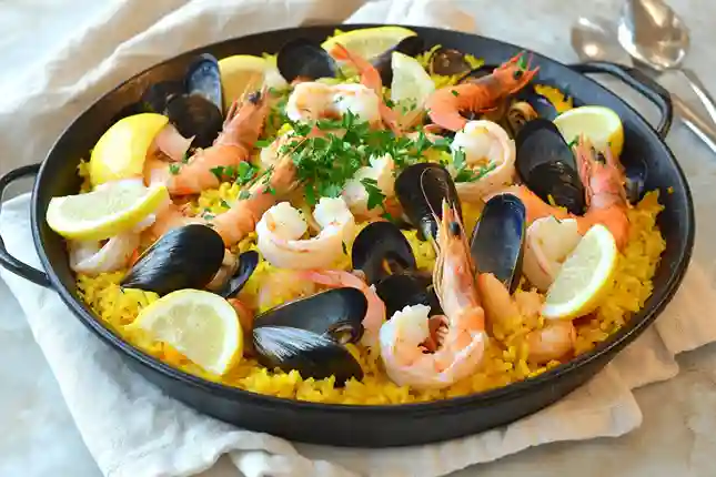 u5855343247 High angle close up shot of a large black paella 2b2406bf 77bd 4d83 8ed0 d197400820f6 0 11zon